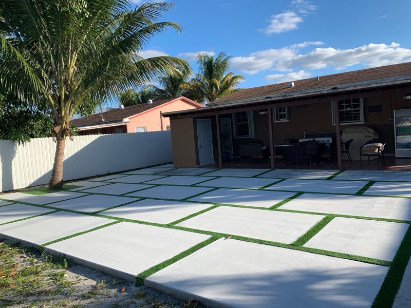 Backyard concrete patio with pool deck integration in South Florida