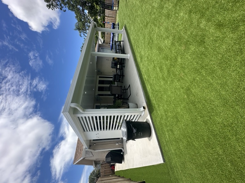 Backyard synthetic grass with concrete inlays in Hialeah FL